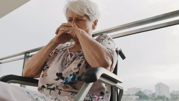 Pensive Sick Disabled Old Lady Sit in Wheelchair Look in Distance Feel Lonely at Home or Retirement alt