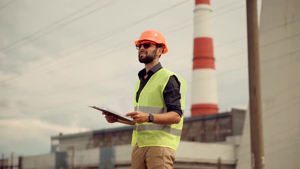Power Engineer On Electricity Towers High Voltage Pylons. Technician And Investor On New Power Plant alt