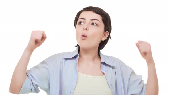 Young Caucasian Girl with Short Black Hair Rejoicing Over White Background alt