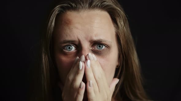A Sad Beaten Up Woman with Wounds on Face is Looking at Camera alt
