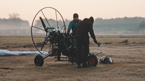 Man Coming and Taking Front Seat at Paramotor Trike alt