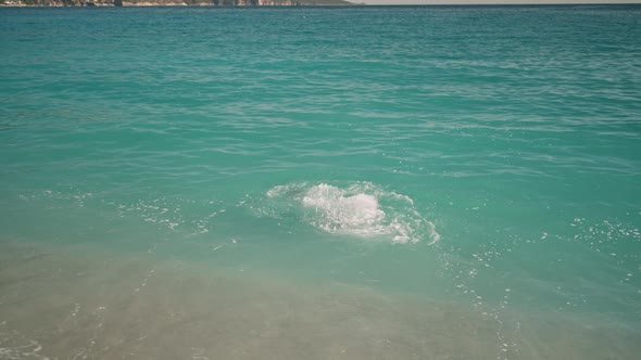 Rear View Athletic Man Dives in Turquoise Water of Mediterranean Sea in Oludeniz Beach in Aegean Sea alt
