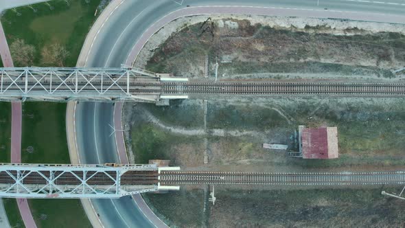 Railway road, top view. Train tracks and railway bridge across the river alt