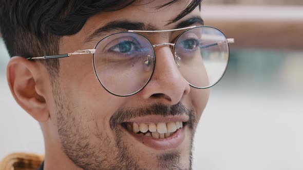 Male Portrait Closeup Young Bearded Indian Guy with Glasses Looks Away Happy Smiling Man Waiting for alt