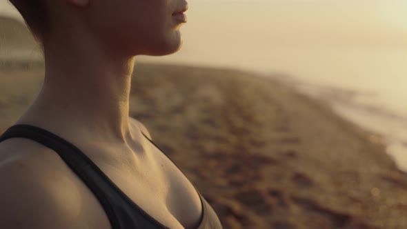 Yogi Woman Meditating Closing Eyes on Sandy Beach Close Up alt