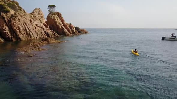 Following a young man kayaking near the cliffs