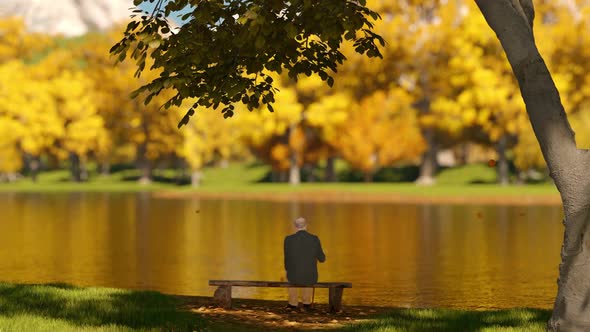 Grandfather Sitting On A Bench In The Autumn Park