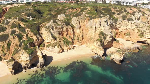 Small enclosed Camilo Beach in rugged Lagos Coastline, Algarve, Portugal alt