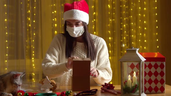 Female Preparing Christmas Gifts Wearing Medical Mask Home