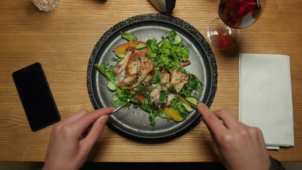 Man Eating Tasty Dinner at Restaurant Table alt