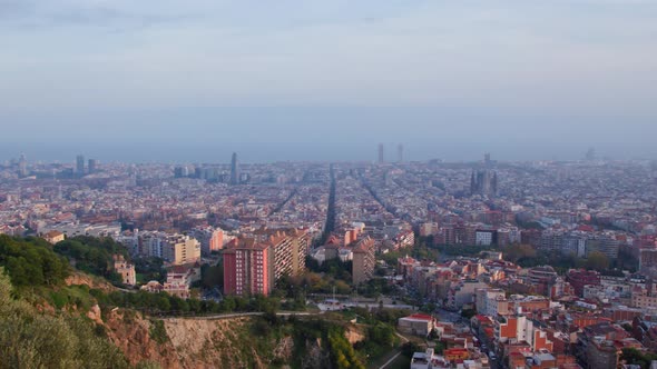 Slow sweeping panorama of the city of Barcelona seen from the Bunkers Del Carmen View point alt