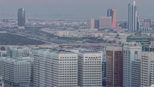 Aerial Skyline of Abu Dhabi City Centre From Above Day to Night Timelapse alt