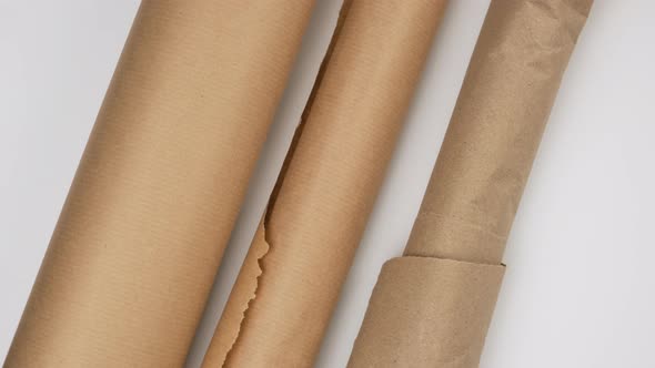 twisted roll of brown parchment paper on a white background, wax baking paper alt