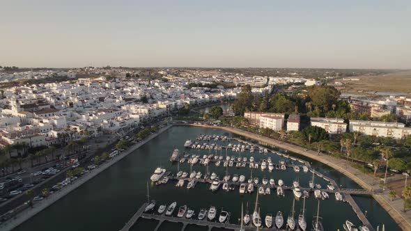 Aerial pullback Ayamonte marina reveal Coastal Spanish village, white house Landscape alt