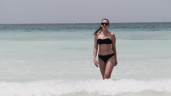 Young Woman in a Bikini Posing on Exotic Beach at the Turquoise Ocean Zanzibar alt
