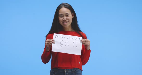 Young Woman Holding Discount Sign alt