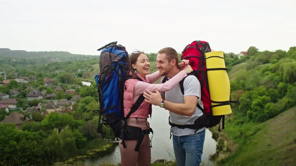 Happy Couple Man and Woman in the Mountains Travel in Search of a Vacation Spot alt