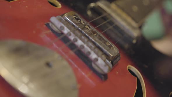 Unrecognized Man Playing the Strings of a Guitar alt