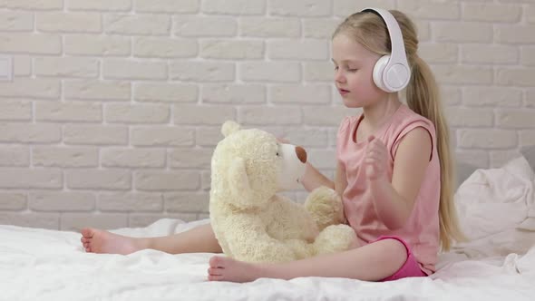 Little Child Baby Girl Listening To the Music with Headphones