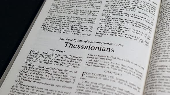 Close Up Shot of  Bible Page Turning to the book of First Thessalonians alt