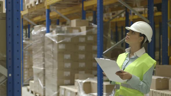 MS Young woman engineer working in factory warehouse