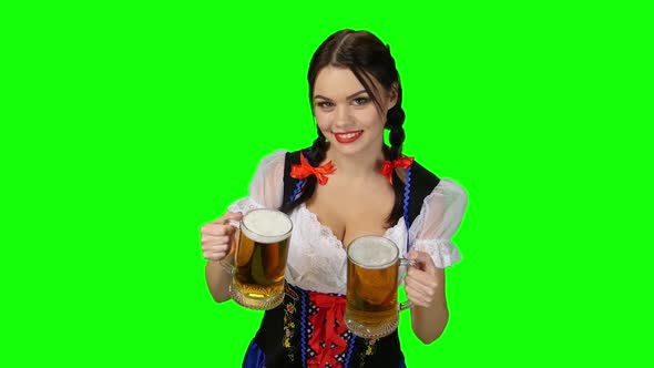 Girl in Bavarian Costume with Beer Glasses in Their Hands. Green Screen alt
