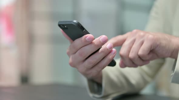 Close Up of Young Man Using Smartphone alt