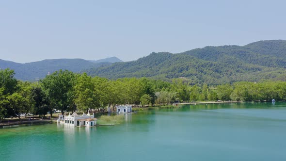 Wide aerial view over lake banyoles boat houses and the mountains on the horizon. Catalonia travel s alt