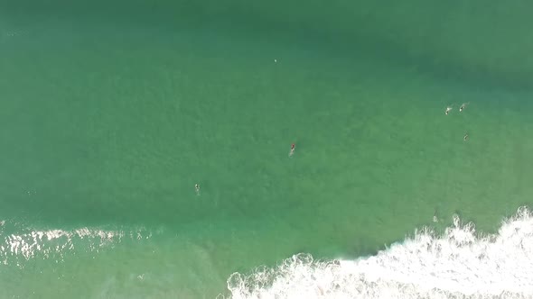 Surfers Between Waves