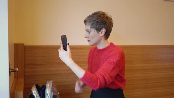 Woman applying make-up at home, Berlin, Germany
