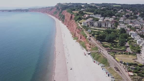 Aerial STATIC CROP, flying toward red sandstone cliffs along the Jurassic Coast alt