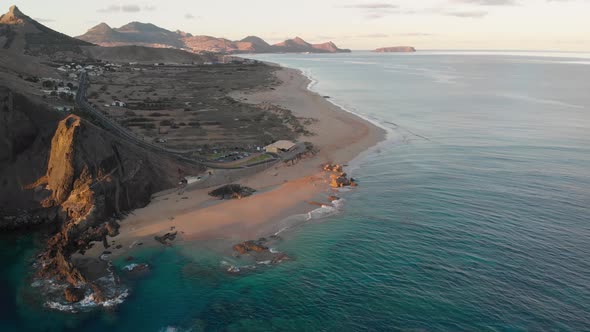 Sensational summertime dramatic flight approaching beautiful sandy beach of Calheta with waves rolli alt