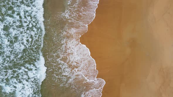 Aerial view of white sand beach and ocean wave alt