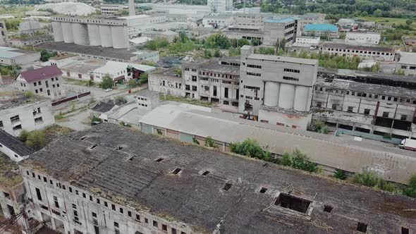 Flight over the destroyed factory. Old industrial building for demolition. Aerial view alt