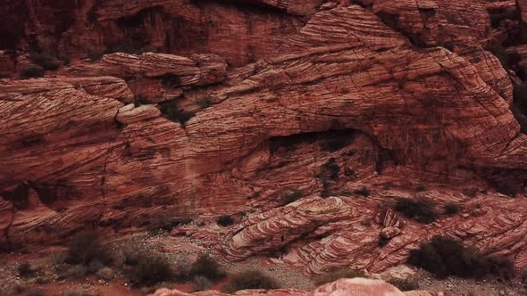 Crane Up from behind Large Rock in Red Rock Canyon to Reveal Canyon Landscape
