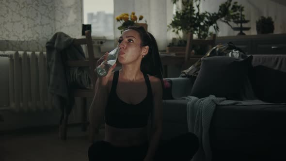 Smiling Sportswoman Drinking Water  alt