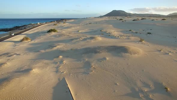 Aerial view of cars on the road of Corralejo Dunes Natural Park in Fuerteventura alt