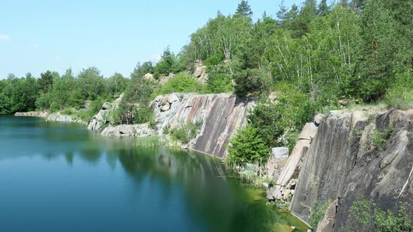 Flooded rock quarry. Beautiful landscape of abandoned and flooded quarry. Czech Republic.