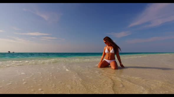 Woman posing on paradise bay beach lifestyle by blue ocean with white sand background of the Maldive alt