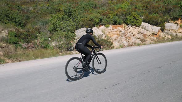 Cycling up the mountain on road bicycle alt