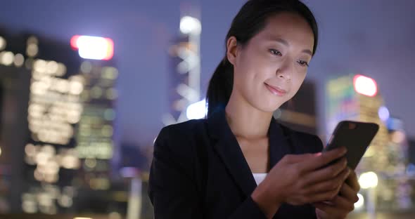 Business woman using mobile phone in Hong Kong city  alt