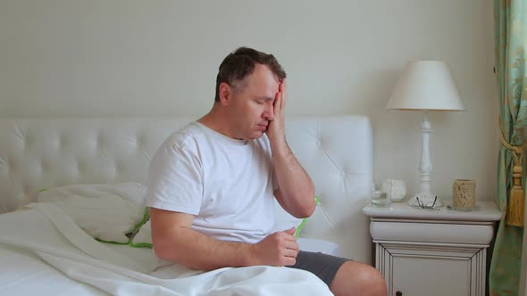 Middle-aged man taking medicine. Taking pills for headaches and fever.