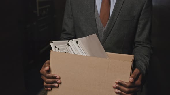 African American Businessman Carrying Box of File Folders alt