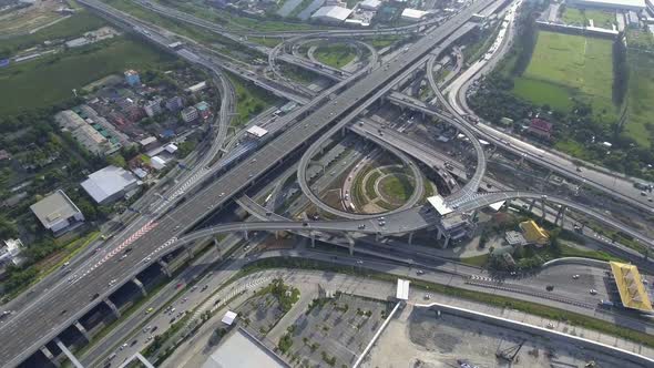 Aerial View of Highway Road Interchange with Busy Urban Traffic Speeding on Road alt