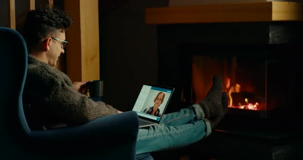 Online Lesson By Laptop in Cozy Home with Fireplace at Lockdown in Winter