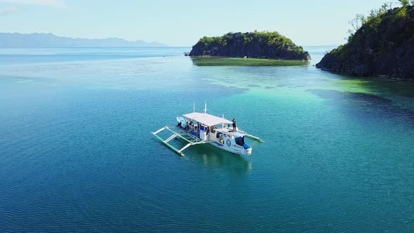Tourists On Boat Floating On Deep Blue Sea Near Island In El Nido Palawan Philippines alt