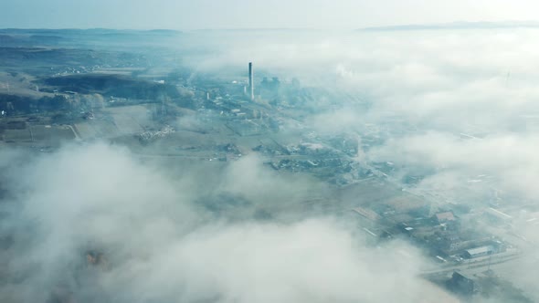 Aerial view of industrial zone covered with autumn fog in Dej, Romania.