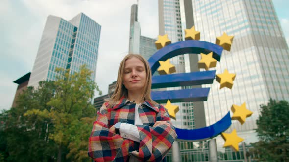 Portrait of European Woman By Euro Sign in Business District of Frankfurt EU