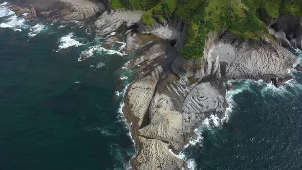 Aerial View of Cape Stolbchaty and Mendeleev Volcano on Background, Kunashir island, Russia.