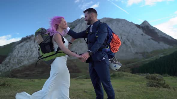 Slow motion shot of bridal couple face to face with hiking backpack alt